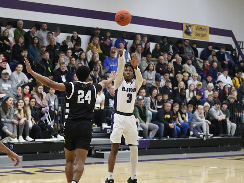 Basketball player pulls up for a three point shot. 