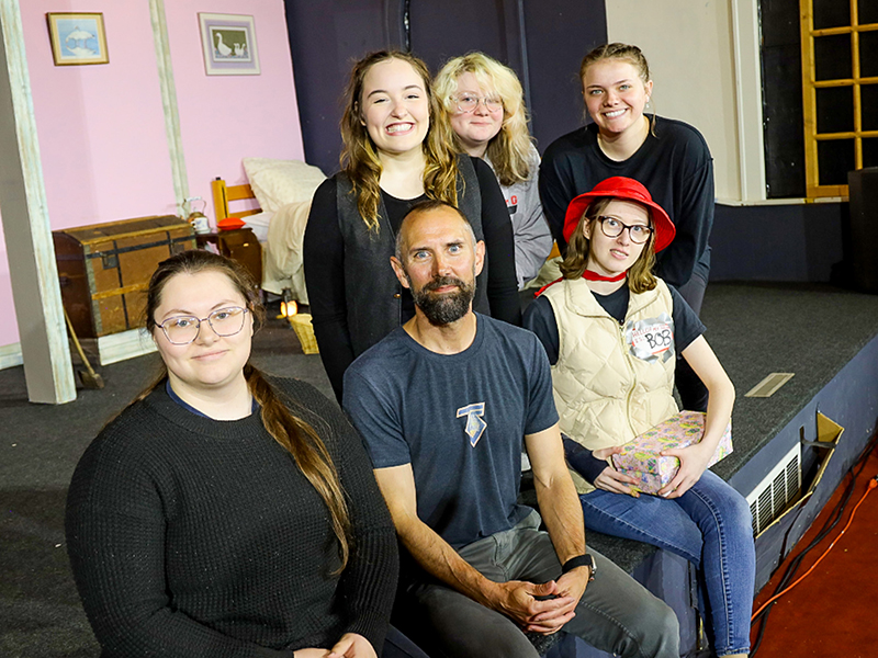 Students gathered on stage after a theatre production, Red Riding Hood. 