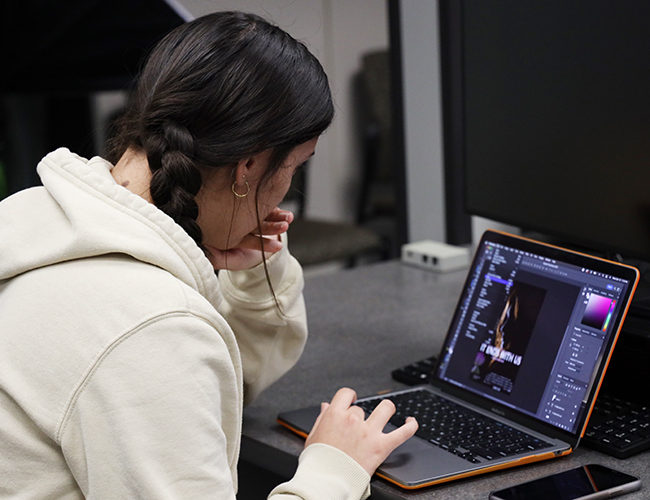 female student on computer designing