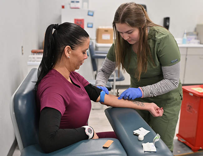 student taking blood