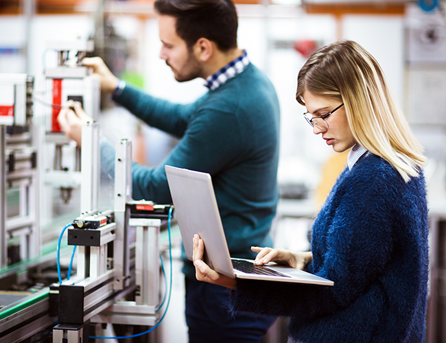 female and male student working on robotics